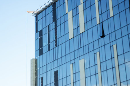 Glass office building, view of the sky reflected in the windows. Concept for work, business,...