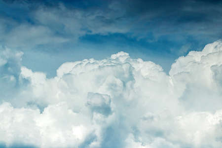 White clouds against the blue sky. Cloudy landscape. Sunny day fluffy clouds.の写真素材
