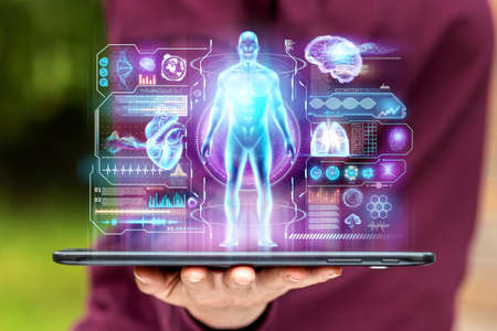 A tablet, map-case lies in the palm of your hand, on the hand is a close-up with various data in the form of a hologram. The concept of information, artificial intelligence, fast dataの写真素材