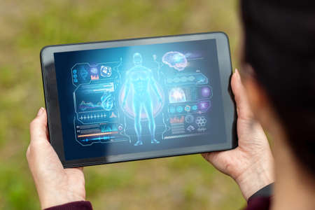 Close-up of a tablet in hands depicting a medical technology hologram graphics. medicine of modern times. Copy spaceの写真素材