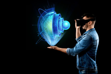 The man holds on his hand a hologram of the earth, the internal structure, the structure of the...