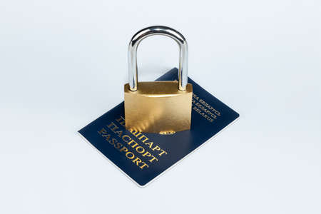 The golden padlock is on the citizen's passport. The concept of violation of the rights of citizens, a ban on movement, the closure of bordersの写真素材