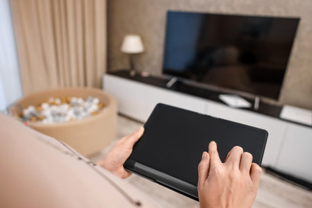 Female hands hold a digital tablet close-up, top view. New technology concept, multimedia
