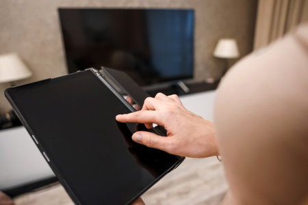 Female hands hold a digital tablet close-up, top view. New technology concept, multimedia