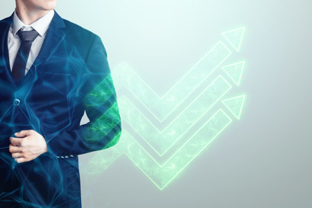 A businessman in a suit, a business man, against the background of a hologram of green arrows showing a growing trend, direction up. Mixed environment, concept for start-up, business, development, motivationの写真素材