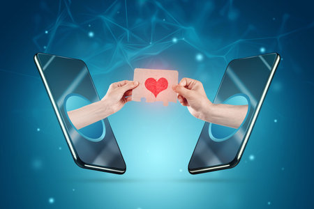 Online acquaintance. Hands come out of the smartphone screen holding puzzles with a drawn heart. The...