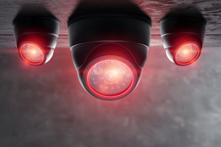 Smart CCTV camera under the ceiling with red lights. Cameras work day and night, video recording in the dark. Protection from thieves and vandalsの写真素材