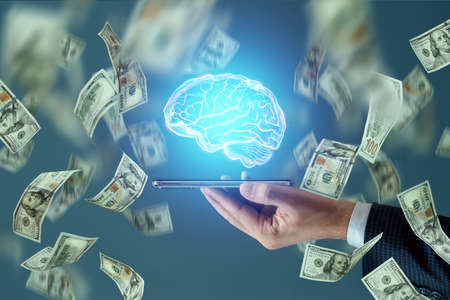 Hundred dollar bills fall on a smartphone with a Brain hologram. Technology concept, exchange of knowledge for money, businessの写真素材