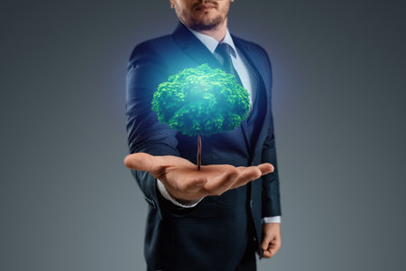 A green tree grows from a man's hand. The concept of financial growth, passive income, investments, dividendsの写真素材