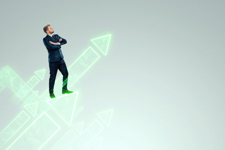 A businessman in a business suit looking for an opportunity against the background of green arrows pointing up. Development concept, start-up, investment search. Copy spaceの写真素材