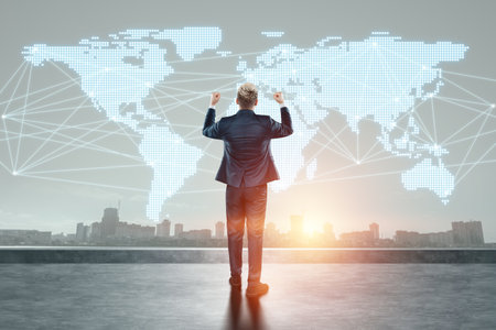 A man in a business suit, a businessman stands against the background of the world map. Concept for international business, global development, online salesの写真素材