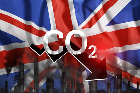 CO2 emissions into the atmosphere. Pipes with black smoke against the background of the England...