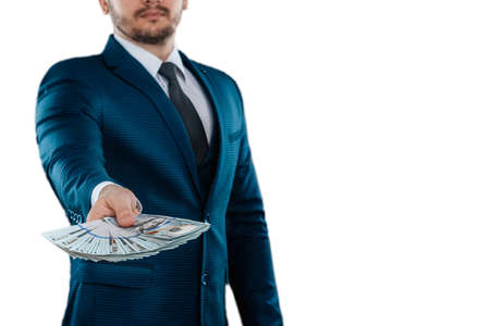 Man, businessman in a business suit holds dollars in his hands isolated on a white background. The concept of success, loan, investment, collateral, salaryの写真素材