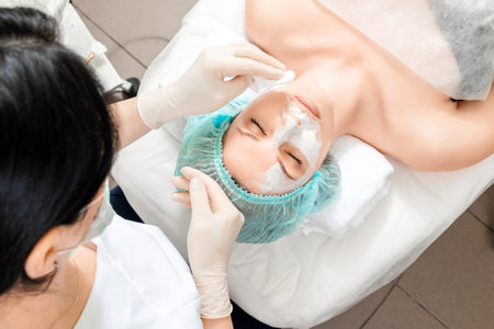 The girl's face is being cleaned after spa procedures, close-up. Skin care, beautician, spa...