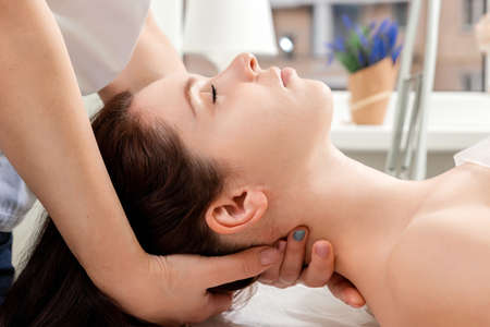 A beautiful girl is doing a neck massage. Skin care, beautician, spa treatments, relaxationの写真素材