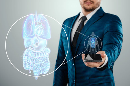 Holographic projection of scanning the internal organs of a person, x-ray in the phone. The concept of modern medicine, digital x-ray, new technologies, human anatomyの写真素材