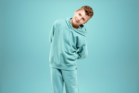 Portrait, cute stylish boy in a blue suit on a blue background. Studio portrait of a child, modern...
