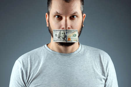 The doctor's mouth is sealed with dollars, money. The concept of buying silence, corruption, lobbyists for money, health insuranceの写真素材