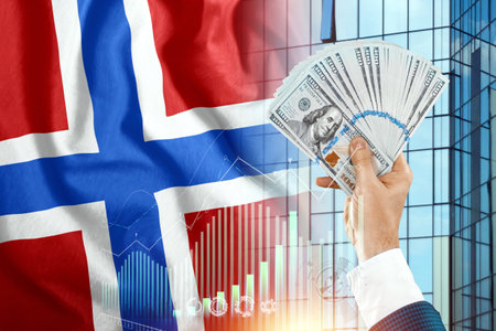 Money in a man's hand against the background of the flag of Norway. Norwegians' income. Financial condition of residents of Norway, taxes, loans, mortgages. State debt of the countryの写真素材