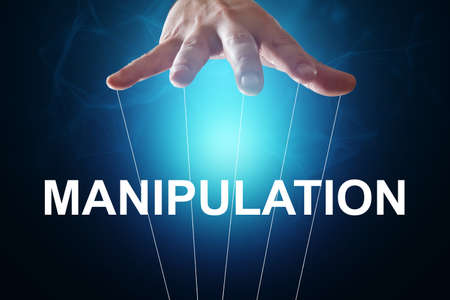 Male hand, puppeteer controls the puppet puppet with strings. A doll on her knees. The concept of world conspiracy, world government, manipulation, controlの写真素材