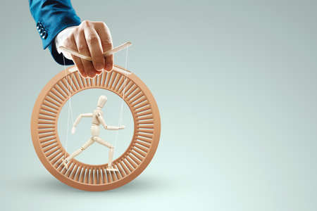 Male hand, puppeteer controls the puppet puppet with strings. The concept of shadow government, world conspiracy, manipulation, controlの写真素材