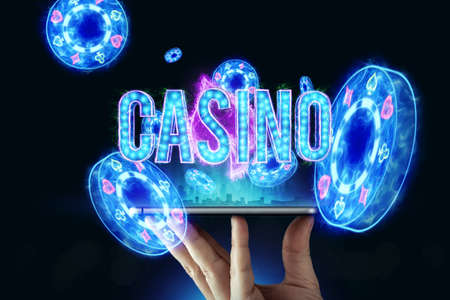 In a man's hand a smartphone with playing cards roulette and chips, black-neon background. Concept of online gambling, online casino. Copy space. 3D illustration, 3D renderの写真素材