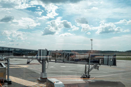 Sleeve to the plane at the airport. International cargo transportation, air travel, transport, air travel, vacation. Copy spaceの写真素材