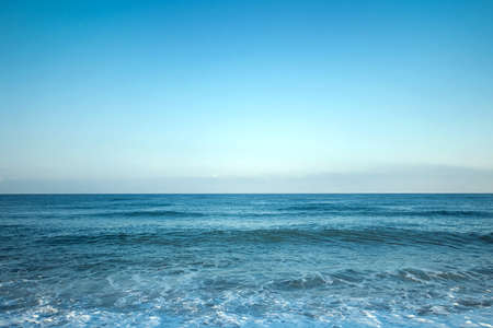 View of the ocean or sea in blue in the morning. Relaxation, calmness concept. Copy spaceの写真素材