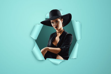 Girl witch in a black dress and hat on a blue punched paper background