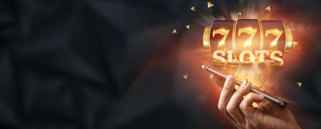 Online casino, smartphone with slot machine with jackpot and gold coins. Online Slots, Lucky Seven 777, Dark Gold Style. Luck concept, gambling, jackpot, bannerの写真素材