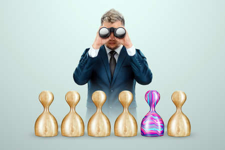 We are hiring, creative background. Recruiting new employees, looking for new candidates for our team, we have posted a vacancy. The business man is on the lookout for unique abilitiesの写真素材