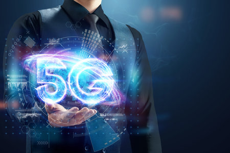 Over hand of businessman 5G hologram, creative background. 5G network concept, high speed mobile...