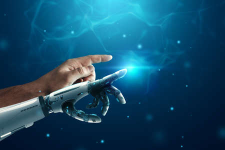 Android robot hand and human hand on a blue background. Future concept, artificial intelligence, robotizationの写真素材