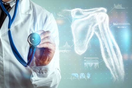 Medical poster, human body anatomy, shoulder joint x-ray, bones hologram. The doctor looks at the patient's x-ray hologram. surgery, modern medicine, technologyの写真素材