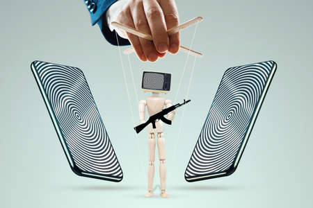 Television zombifies people through propaganda. Manipulation of the crowd with the help of fakes, false information. The concept of propaganda, information warfare, hybrid warfare, fakes, phishingの写真素材