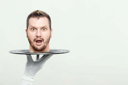 The waiter holds a man's head on a tray. Metaphor, bring the head, head off the shoulders, guilt, repentance, problems, punishment, justice. creative design, magazine styleの写真素材