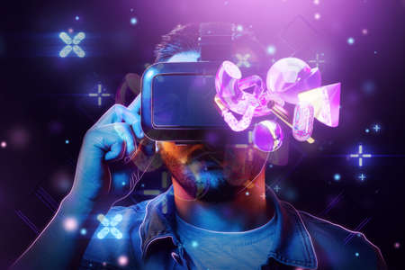A man with glasses on the background of Virtual Reality, the metaverse. Future metaphor, metaverse technology concept, cyberuniverse, communication, blockchain, futuristic network. mixed media.の写真素材