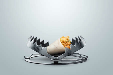 french fries in a large metal bear trap, close-up. The concept of gluttony, obesity, fast food, addiction, malnutritionの写真素材