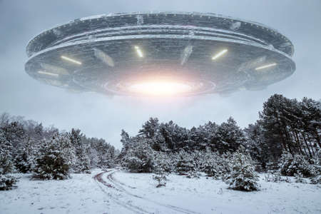 UFO, alien saucer hovering over the winter landscape in the sky. Unidentified flying object, alien invasion, extraterrestrial life, space travel, spaceship. mixed mediaの写真素材