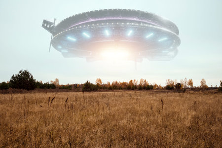 UFO, an alien saucer hovering above the field in the clouds, hovering motionless in the sky....
