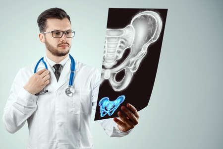 Doctor and Hologram, anterior ultrasound image of the male pelvis, sacrum. Anatomy, medicine, scientific conceptsの写真素材
