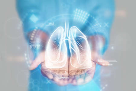 Medical concept, doctor's hands in a blue coat close-up. lung ultrasound, x-ray, hologram. Medical care, anatomy, doctor's appointment, coronavirus, treatment. mixed mediaの写真素材
