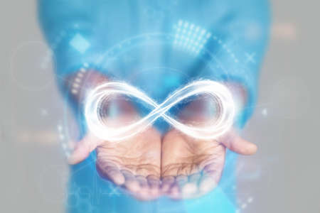 The concept of infinity. male hands hold infinity icon. mixed media.の写真素材