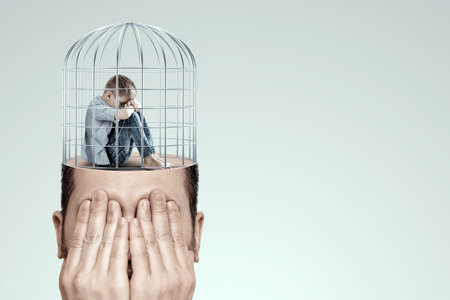 Stress, depression, emotional burnout. Malchi, the child sits with his head down on his knees, sad in a cage. Unhappy, in a bad mood. Modern design, magazine styleの写真素材