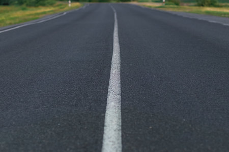 Asphalt road going into the distance on a summer evening.の写真素材