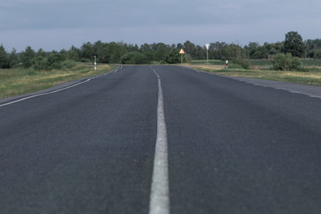 Asphalt road going into the distance on a summer evening.の写真素材