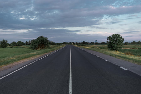 Asphalt road going into the distance on a summer evening.の写真素材