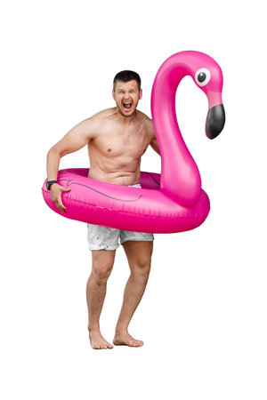 Adult bearded man with pink flamingo isolated on white background showing emotionsの写真素材