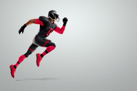 American Football player in red and black uniform in running pose on white background. American Football, advertising poster, template, blank, sports. 3D illustration, 3D renderingの写真素材