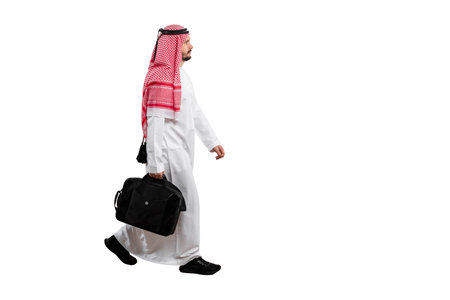 Male Arab with briefcase isolated white background in traditional costume. Ready for cutting and editing.の写真素材